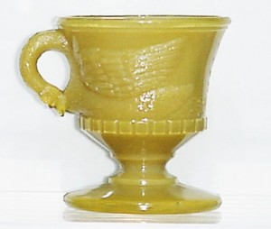 "Swimming Swan" mug in odd opaque mustard glass, attributed to Atterbury & Company, Pittsburgh.