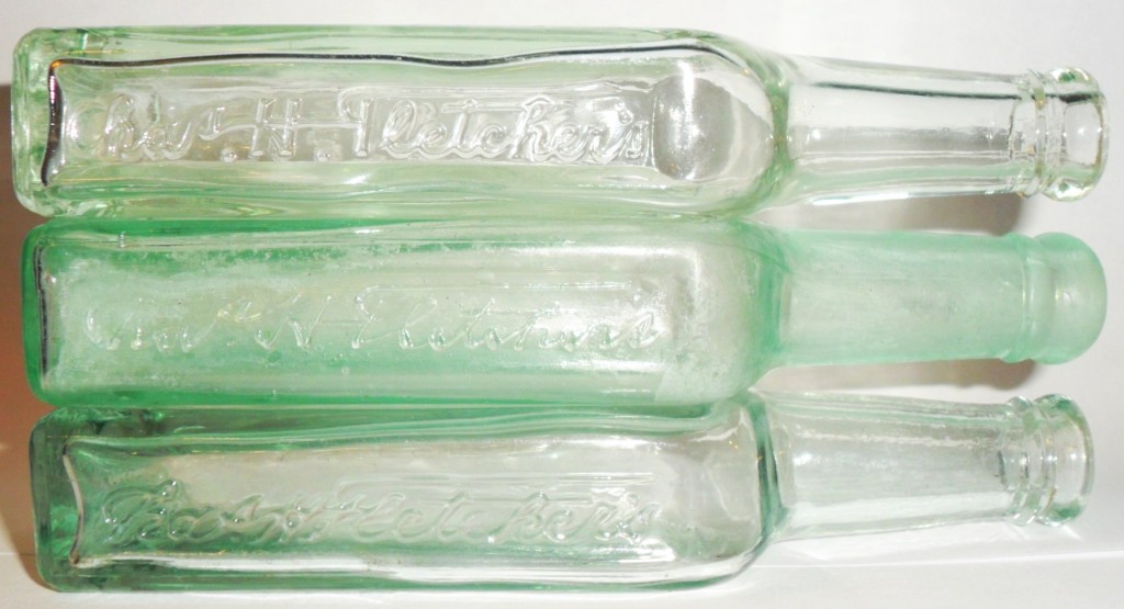 Trio of Chas H. Fletcher's antique glass CASTORIA laxative bottles