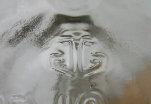 Anchor Glass Container Corporation logo, here as embossed on the base of a Jim Beam handled liquor jug, date coded 2006.