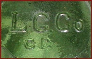 L.G.CO. mark : "L G CO / CF" mark on base of yellow-green wax sealer fruit jar made by Lindell Glass Company, Saint Louis, MO. 