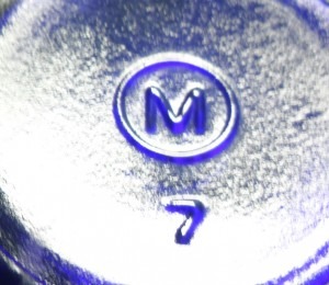 M in a circle bottle base