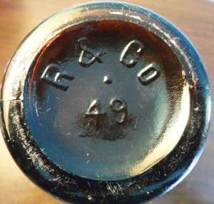 Base of "R & CO" bottle with mold number "49", made by Reed & Company of Massillon, Ohio.