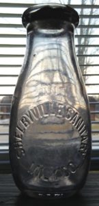 "F G W" on lower heel area of milk bottle made for Shelbyville Sanitary Milk Company. 