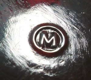 Mosser Glass Company - "M inside a circle" mark on the base of ruby red toothpick holder/votive candleholder.