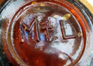 MT.L. mark on base of amber beer or soda bottle. (Photo courtesy of Seth Miller)