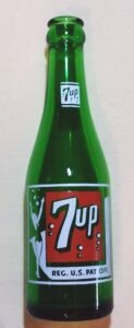 Emerald Green glass 7-UP soda bottle from 1950, marked with DURAGLAS on base, made by Owens-Illinois Glass Company