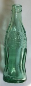 Typical older "classic" greenish-aqua Coke bottle with the Hobbleskirt shape.  This one is marked "MT. VERNON / ILL" on the base, as shown in the picture above, and was made by Owens-Illinois Glass Company.  The date code is unclear but may be for 1947.