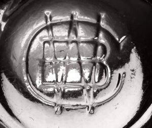 Unidentified CBW monogram mark on base of possible food bottle or jar with ten fluted/paneled sides.