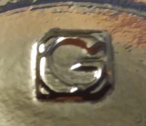 Gamer Packaging 'G mark', seen on base of amber glass Fentimans Ginger Beer bottle, made circa 2010.