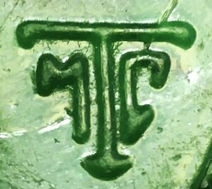 Thatcher Glass "MTC" mark on emerald green "beach glass" shard from a juice bottle.