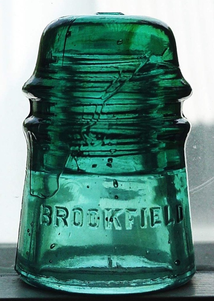 CD 121 "Toll" (Long Distance) style insulator, marked BROOKFIELD, in a teal-aqua colored glass. This probably dates from the 1906-1921 period.