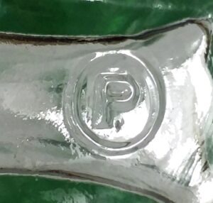 P in a circle mark used by Pierce Glass Company - here on the bottom of a Fletcher's Castoria bottle