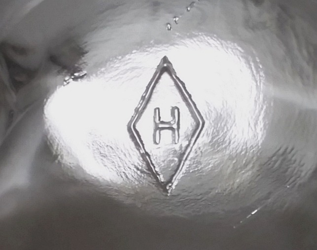 "H inside a diamond" mark on the bottom of a clear glass punch cup made by Heisey Glass Company