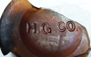 HGCO mark on amber base shard from blobtop beer bottle