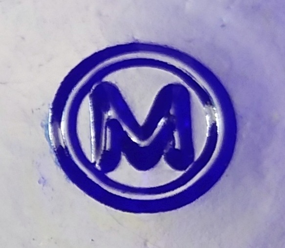 "M in a circle" trademark used by Maryland Glass Corporation of Baltirmore, Maryland - here on a cobalt blue jar or bottle.