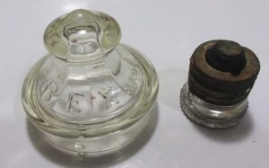 Two small vintage collectible items marked "PYREX":   Glass Percolator top and small electrical plug-style fuse. The percolator top is embossed "PYREX  MADE IN U.S.A." and the fuse is marked in raised lettering on the base "PYREX   G.E.CO.  U.S.A.".