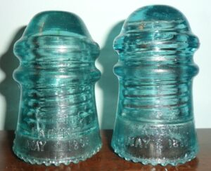 Hemingray No. 9 glass insulators: Two "Script" examples (rear skirt- dated side)