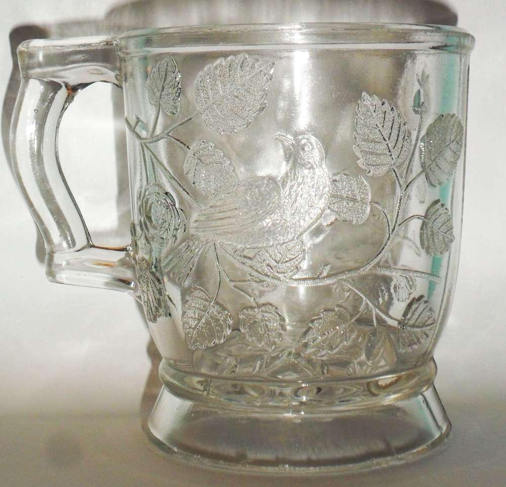 Bryce Bros or U.S. Glass version of "Robin in a Tree" mug in clear, circa 1880s/1890s.