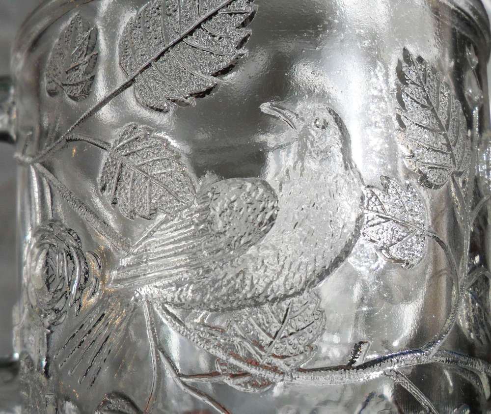 Detail of bird design on "Robin in a Tree" mug made by Bryce Bros. or U.S. Glass Company.