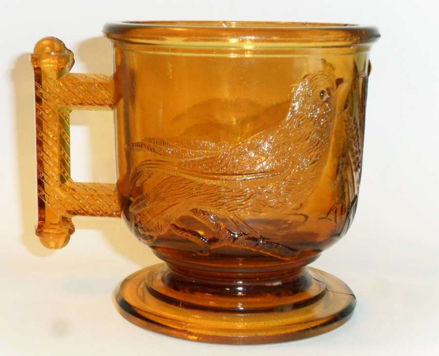 No. 3 size EASTLAKE mug in orange amber, made by Atterbury & Company.