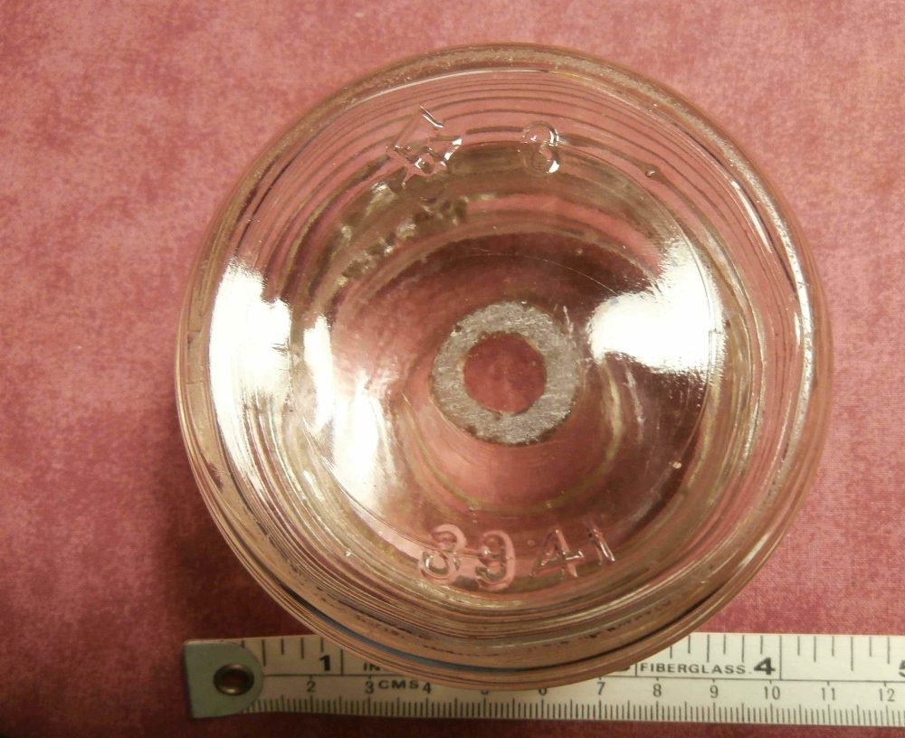 GC unknown glass object - Photo #2. This is embossed "3941" along with the angular GC mark. (Photo courtesy of Diane Enns).