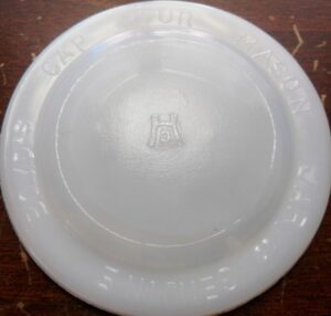 Hazel-Atlas Glass Company milk glass liner/disc with "H over A" logo.