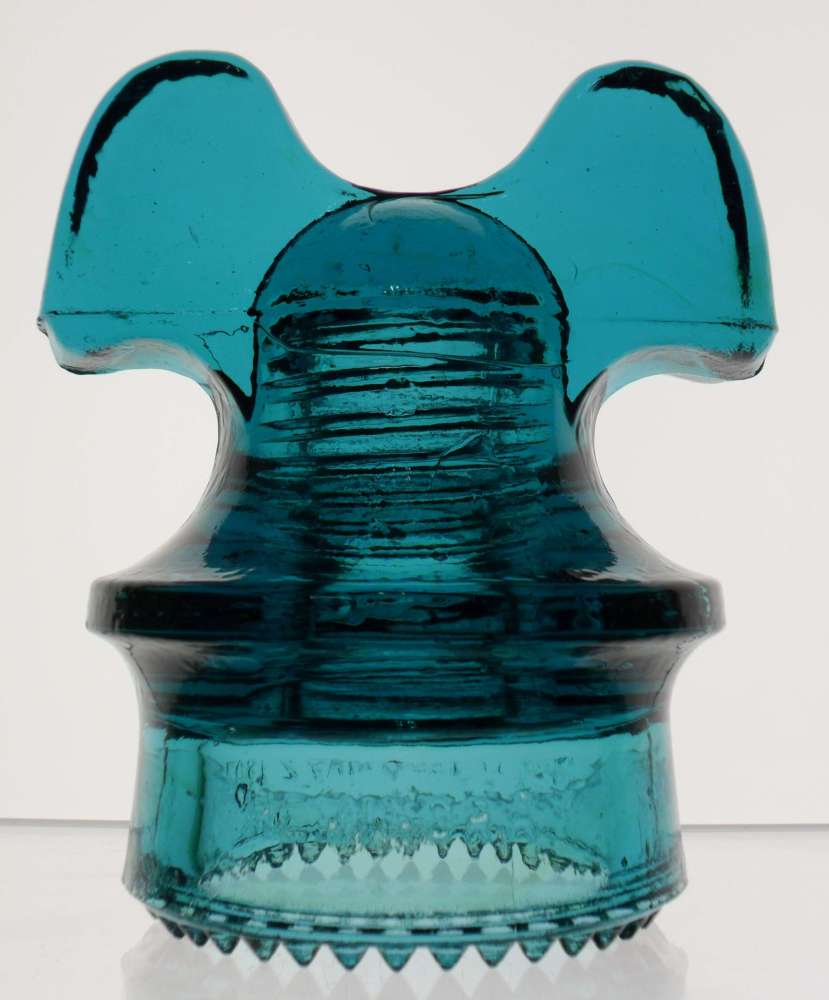 "Hemingray Blue" or blue aquamarine CD 257 "Mickey Mouse" style power line insulator made by Hemingray Glass Company, Muncie, Indiana. This is marked "HEMINGRAY // PATENT / JUNE 17 1890 - MAY 2 1893" on the front skirt area.