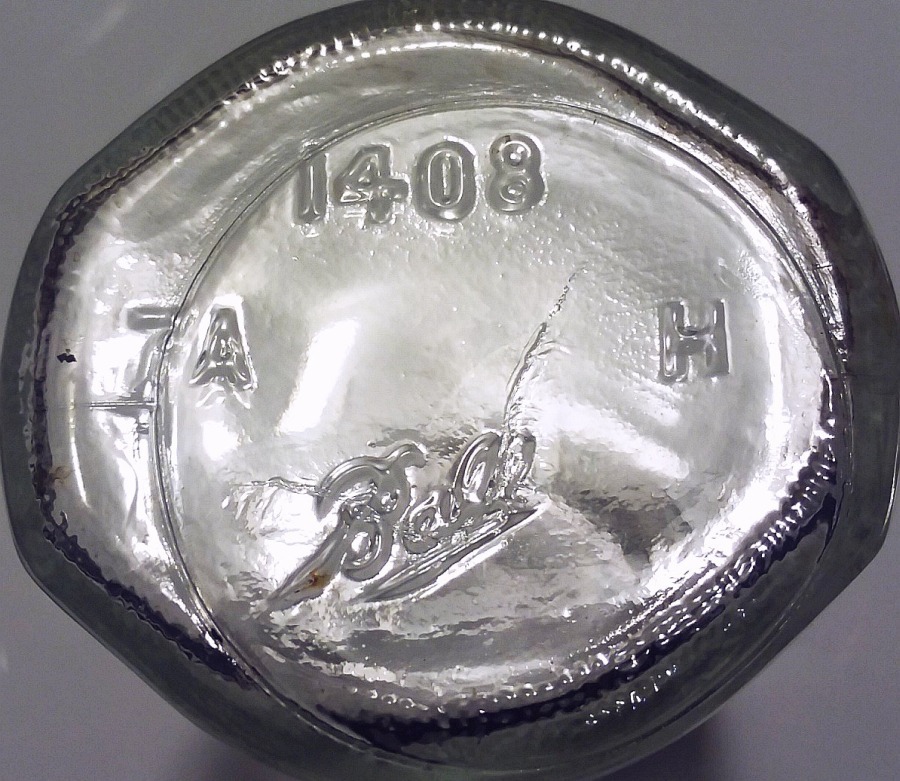 Base markings on the bottom of a Ball Bros Glass Company honey jar in clear glass. This jar mold was numbered "1408" at the Ball factory.