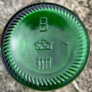 "House" Logo used by Nienburger Glas, Nienburg, Germany. on bottom of green glass bottle. (Photo courtesy of Allen McCabe).