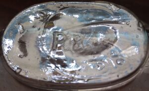 "PB" on base of clear handmade pumpkinseed or picnic flask