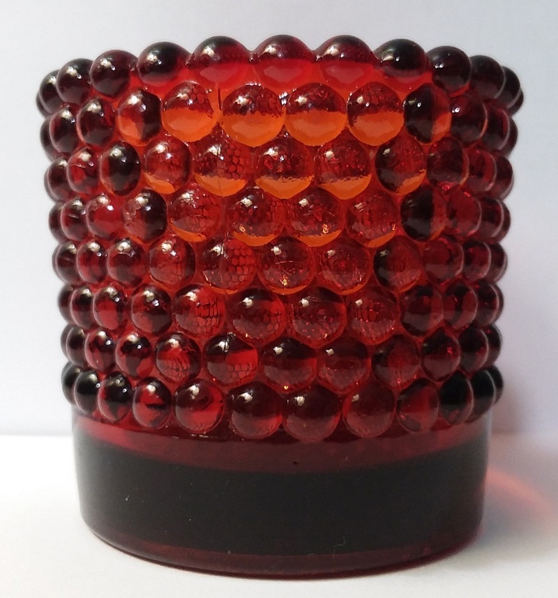 Reddish colored glass hobnail votive candle holder - made by Crescent Glass Company - Wellsburg WV- Patent July 11, 1939.