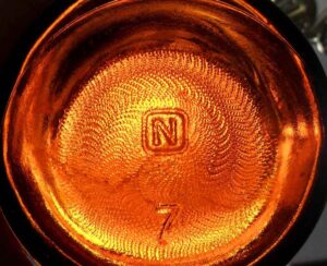 Obear Nester Glass Company - Amber Purex bleach bottle with "N in a square" mark on the base.