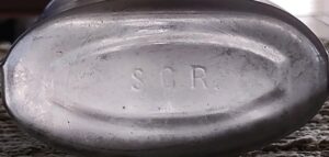 S C R or S G R on base of clear glass honest measure flask - David Weaver photo