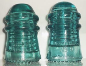 Hemingray NO. 9 insulators: Two "Script" style mold examples (front skirt).