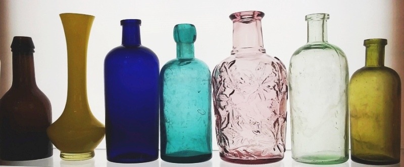 Old Antique bottles - various colors, on shelf.