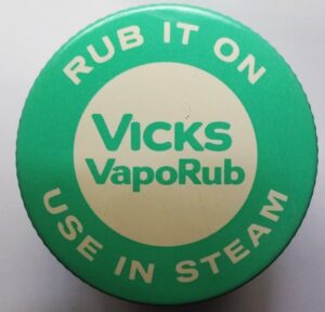 Vicks VapoRub metal jar lid, lettered "RUB IT ON / USE IN STEAM" aqua colored graphics, 3.1 ounce size, dates from 1970s or early 1980s.