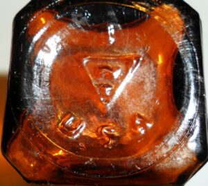 "W over T in Triangle" mark on the base of a typical amber merthiolate or iodine bottle.