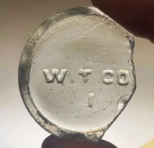 W.T.CO. (Whitall Tatum Company) mark on bottle base shard (Photo courtesy of Jodi Gerstenhaber).