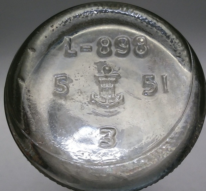 Base of clear Grapette soda bottle, showing typical "Anchor and H" trademark. This particular bottle carries a 1951 date code and was made at their #5 plant (Connellsville, Pennsylvania). The "L-898" was a code number for that particular bottle mold / design. The "3" is a mold cavity number.