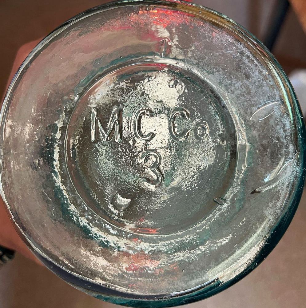 Base of aqua "M C CO" wax sealer jar, probably circa 1880s. (Photo courtesy of Becca Hill)