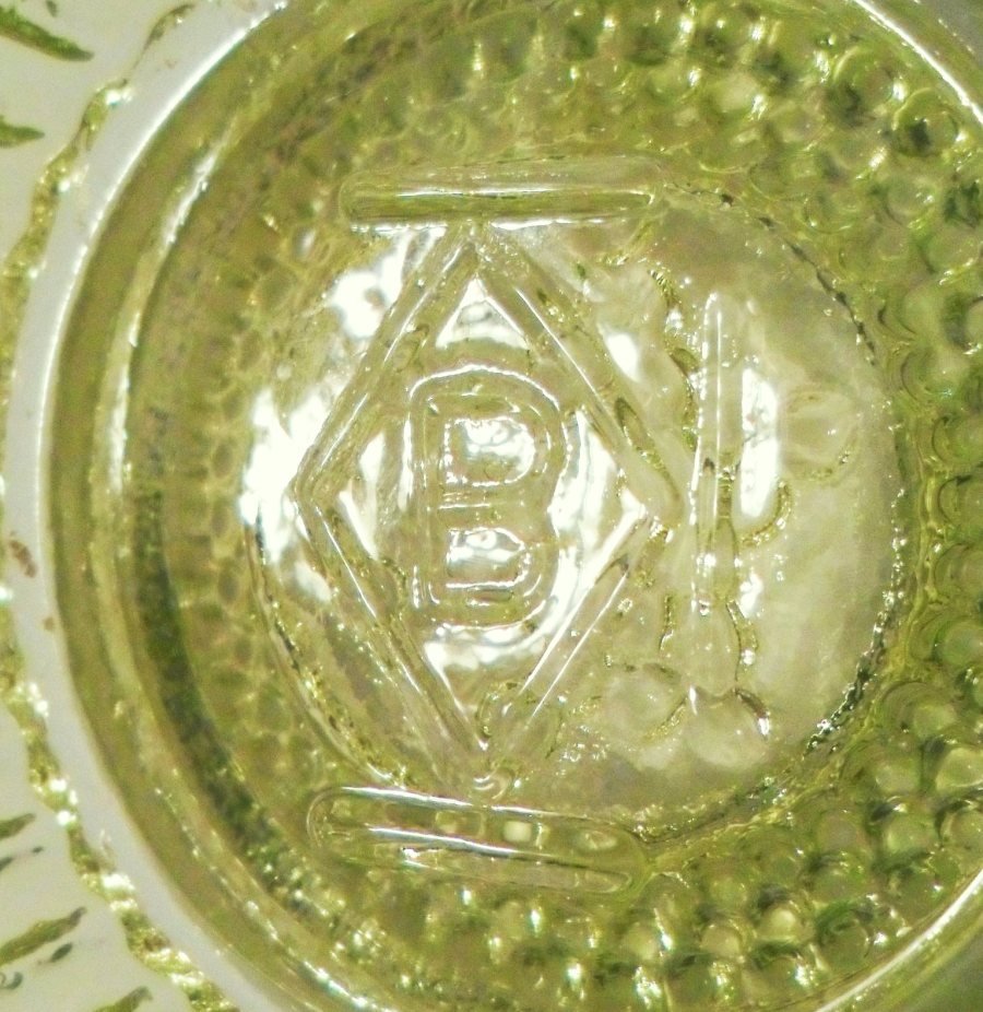 "B in a diamond" mark on inside of Star & Dewdrop master salt dish in vaseline glass, made in 1994. This mark has 3 lines outside the diamond, indicating production between 1993-1998.