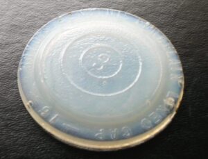 Boyd zinc jar cap insert - semi-translucent glass. This piece has a mold number "3" in the center.