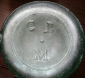 C B M mark on base of antique light green glass pickle or "Chow Chow" bottle made in Great Britain, circa 1870s-1880s. There has been no definitive proof found (so far) on what these initials actually mean.