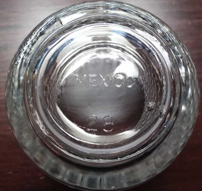 Base of clear glass hobnail style votive candleholder marked "MEXICO" on bottom. Probably a product of either Vitro or Libbey Glass.