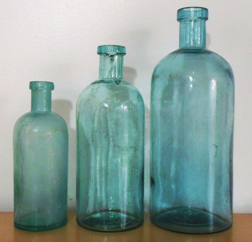 Group of three F.C.G.CO. "generic" chemical or "druggists' packer" bottles made by Falls City Glass Company, measuring 6 inches, 7.5 inches and 9 inches in height. 