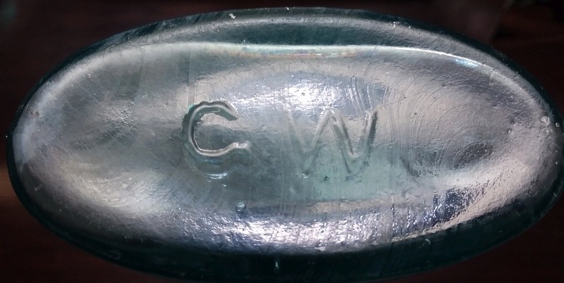 Base of Great Western Glass oval bluing or "Jamaica Ginger"- type medicine bottle, shown at center in above group photo.