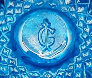 Imperial Glass Company "I superimposed over a G" trademark, as seen on the bottom of a blue "Octagon" toothpick holder.