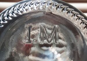 "I. M" on base of clear sauce bottle, sold by supplier I M Packaging of Montreal, Canada.