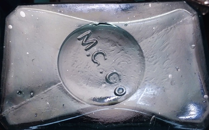 M.G.CO. mark on base of aqua rectangular "John Bull/Extract of Sarsaparilla/Louisville Ky" bottle. Mississippi Glass Company product.