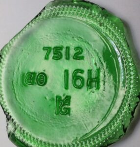 Madera Glass Company "MG" mark on green glass base shard of wine bottle. "7512" is mold design number assigned to that type of bottle.